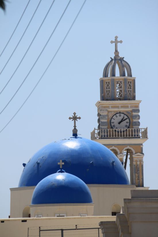 Picture of the  Blue Church Domes And Clock Tower Aligned Against Blue Sky  - Fira, Santorini, Greece