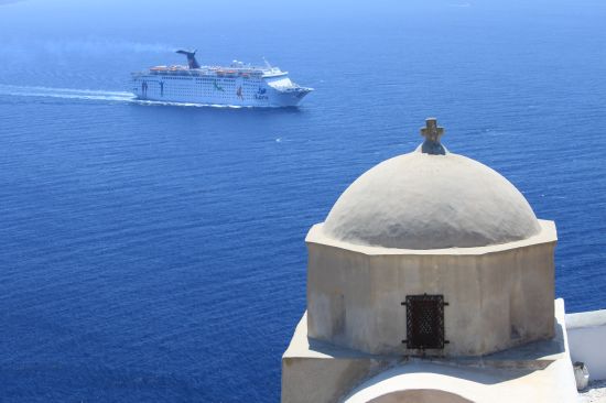 Picture of the  Ibero Cruceros Grand Celebration Cruise Ship In Background - Oia, Santorini, Greece