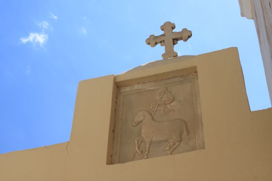 Picture of the  Lamb Placard Below Cross Catholic Cathereral  - Fira, Santorini, Greece