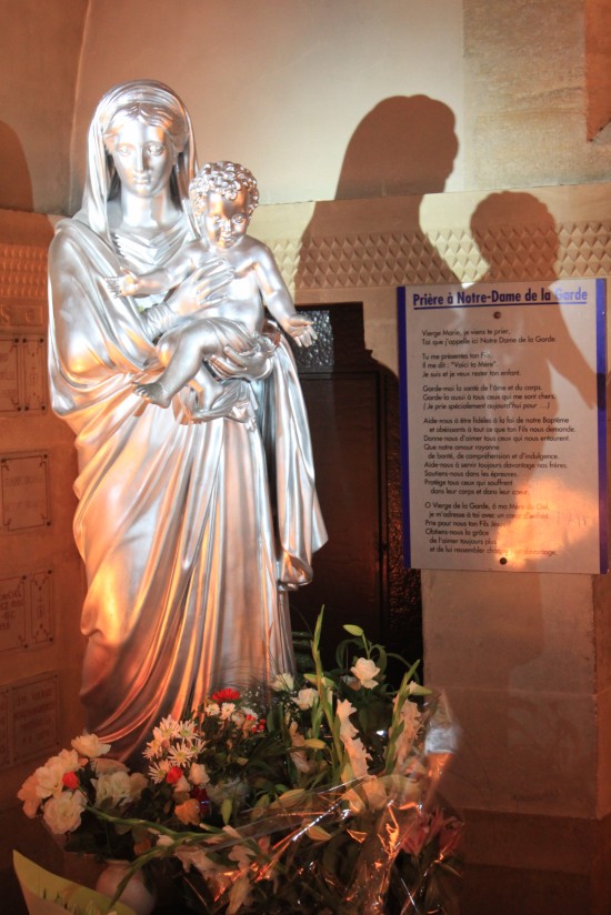   Statue Of Mother Mary And Baby Jesus With Shadow Marseille France