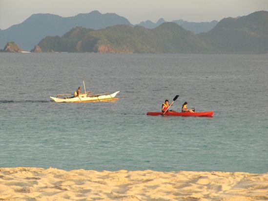 club paradise coron philippines couple in canoe picture